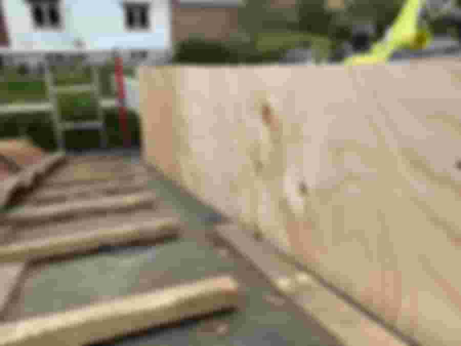 Snickare monterar täcksidor på takets gavlar under renovering.